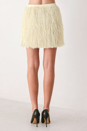 A model wearing a cream-colored, shaggy, textured mini skirt | FREEMARKET