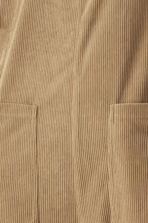 Woman wearing a brown corduroy jumpsuit with U neckline, pockets and adjustable straps | FREEMARKET