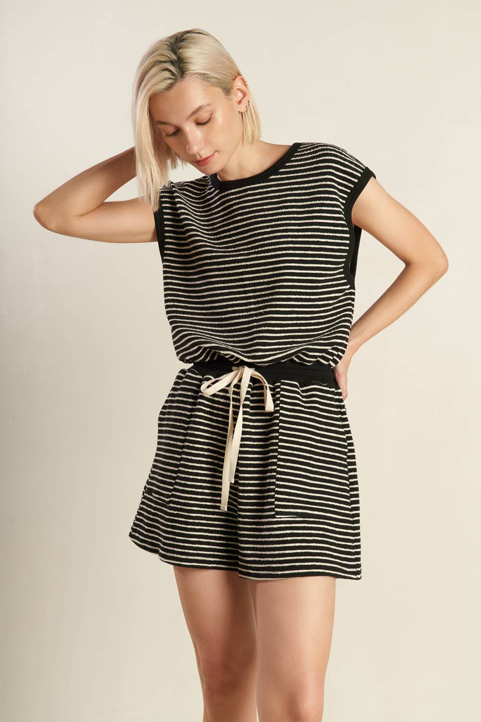 A striped knit romper featuring round neckline, sleeveless, draw string waist, side pocket, surplice back with button closure
Details:
Self : 95% Polyester 5% Spandex
Size & Fit
- Model is 5`8" And Wearing Size Small
- Measurements Taken From Size Small
- Approx. Length: 33"