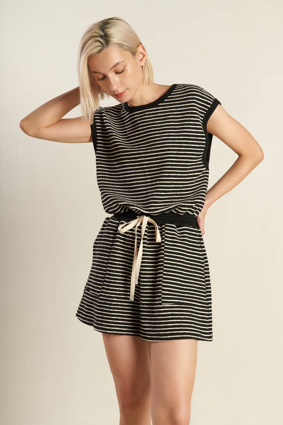 
A striped knit romper featuring round neckline, sleeveless, draw string waist, side pocket, surplice back with button closure

Details:

Self : 95% Polyester 5% Spandex

Size &amp; Fit

- Model is 5`8" And Wearing Size Small
- Measurements Taken From Size Small
- Approx. Length: 33"