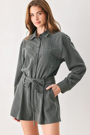 A woman modeling a dark gray pinstriped long-sleeve shirt dress with a tie waist belt | FREEMARKET 
