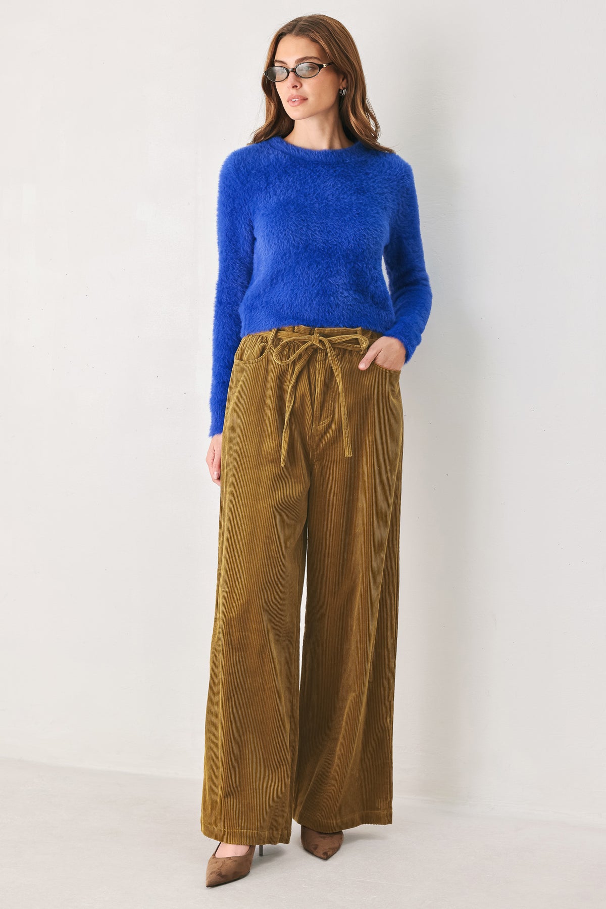 A woman modeling a bright blue fuzzy long-sleeve sweater and wide-leg brown corduroy pants | FREEMARKET