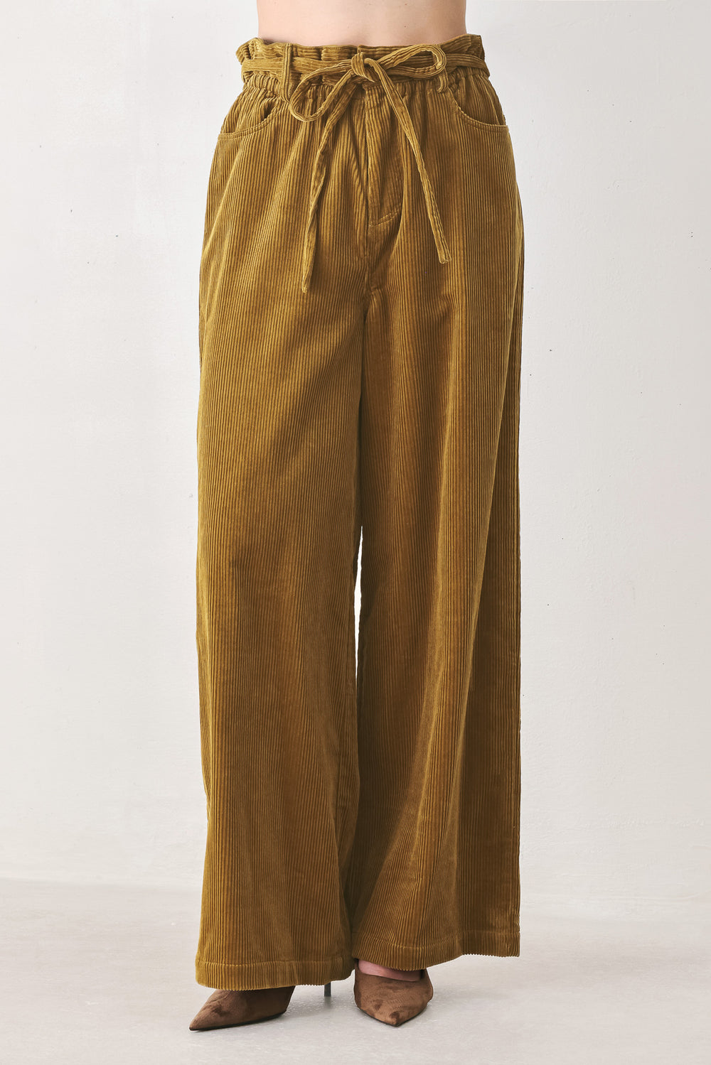 A woman modeling a cream corduroy wide-leg trousers | FREEMARKET
