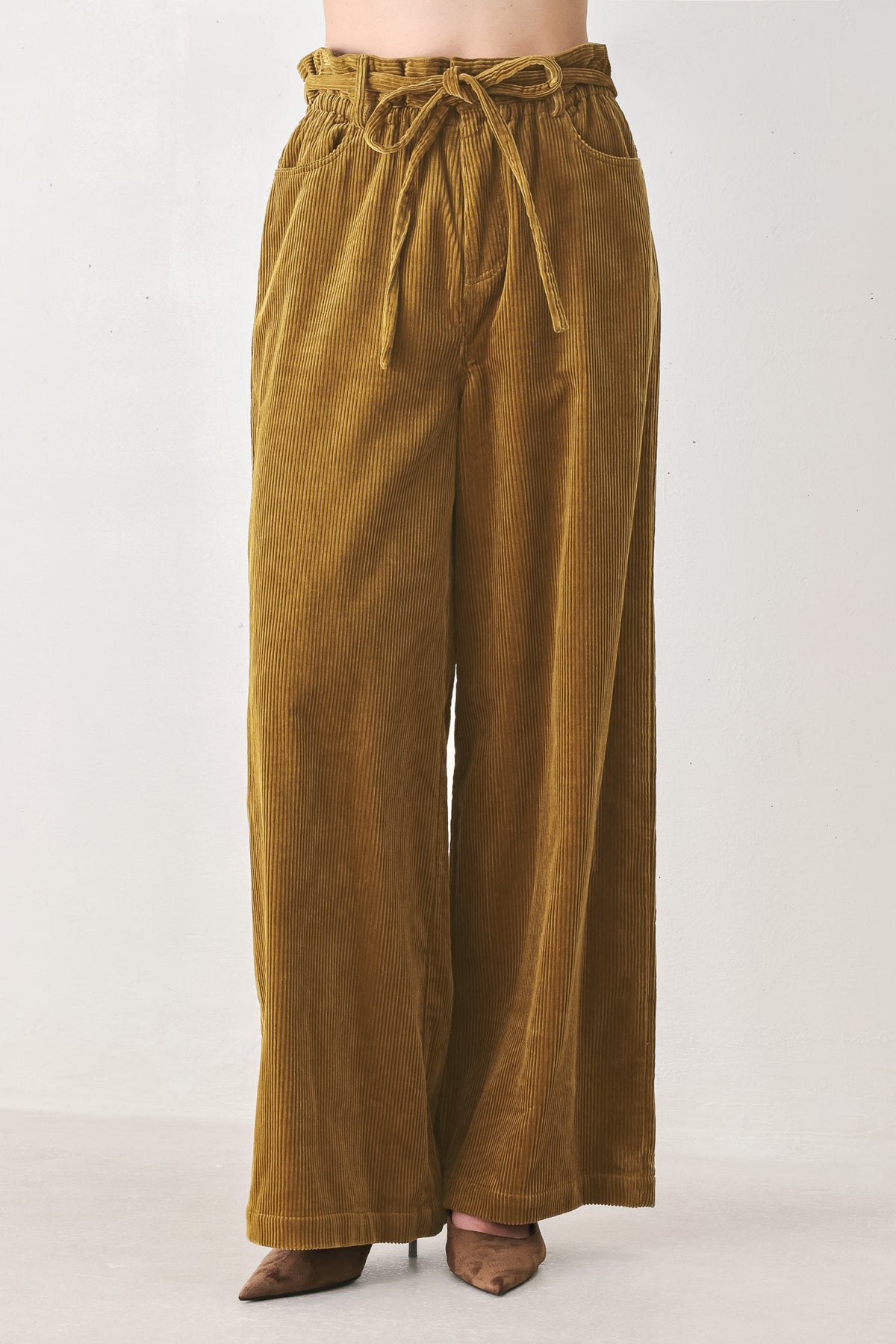 A woman modeling a high-waisted, wide-leg brown corduroy pants with a drawstring waist | FREEMARKET