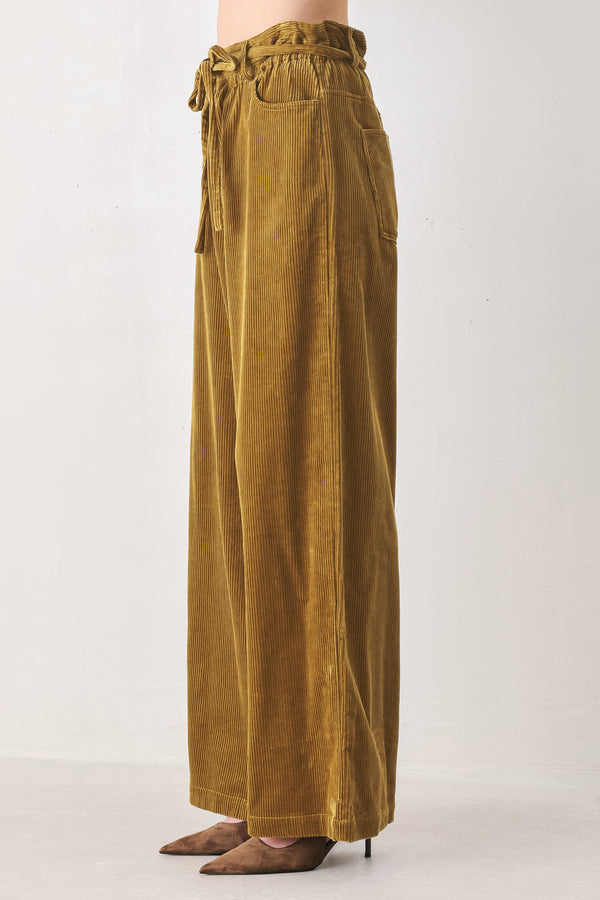 A woman modeling a high-waisted, wide-leg brown corduroy pants with a drawstring waist | FREEMARKET