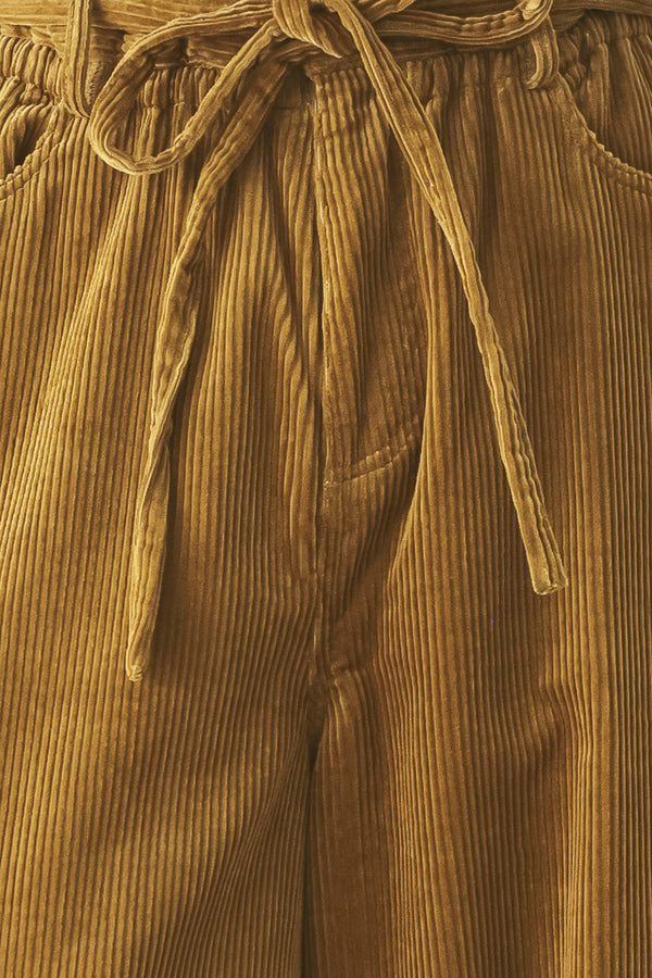 A woman modeling a high-waisted, wide-leg brown corduroy pants with a drawstring waist | FREEMARKET