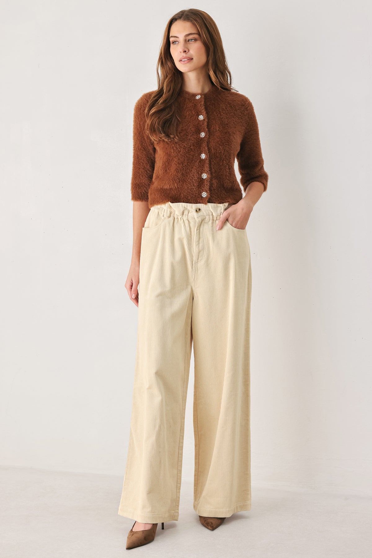 A woman modeling a cream corduroy wide-leg trousers | FREEMARKET