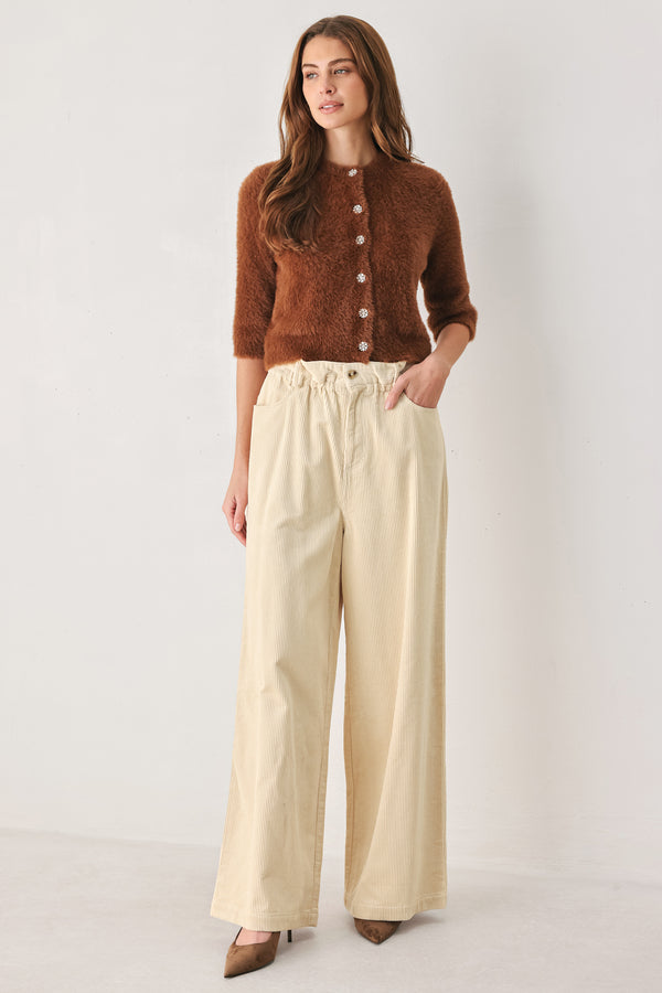 A woman modeling a cream corduroy wide-leg trousers | FREEMARKET