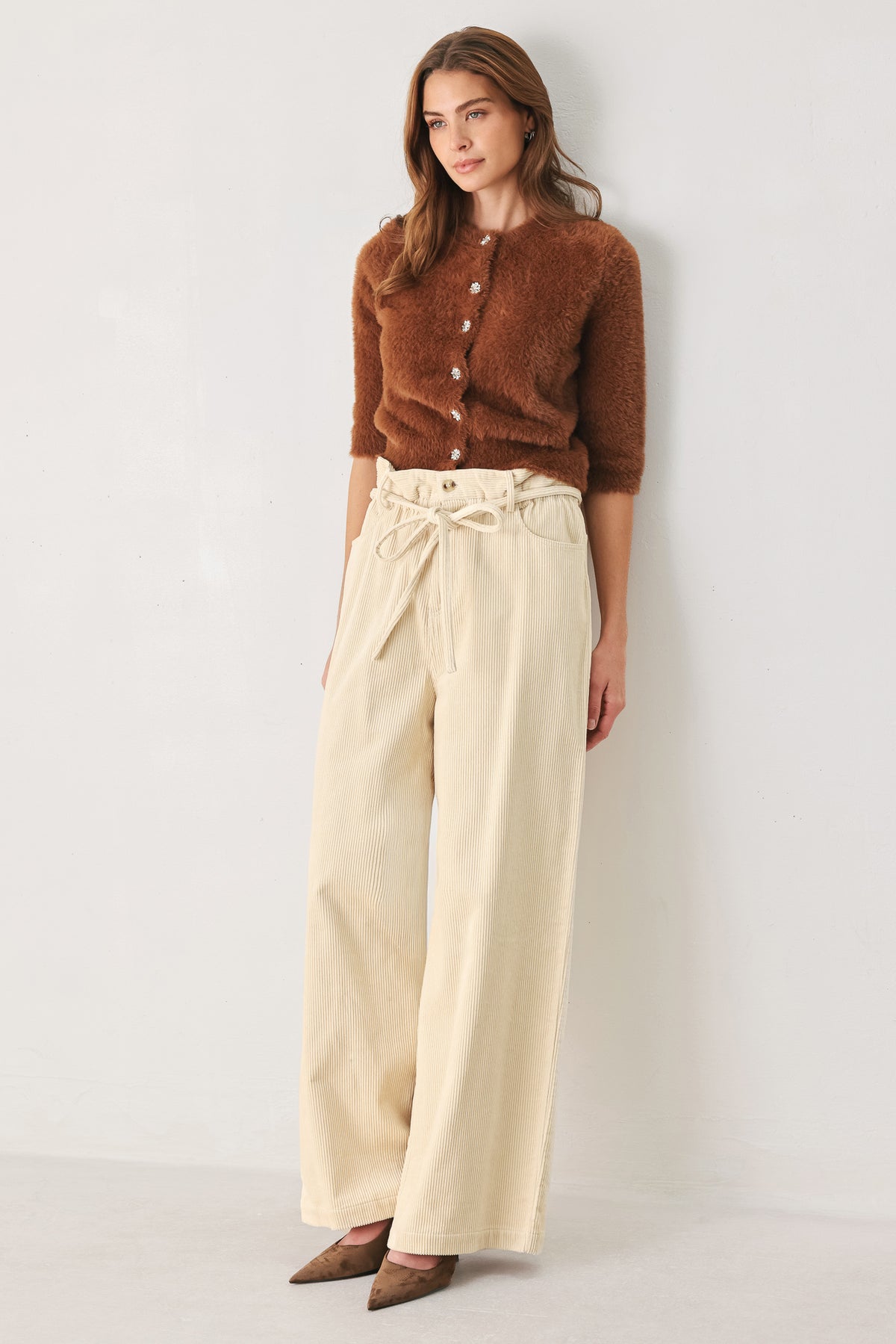 A woman modeling a cream corduroy wide-leg trousers | FREEMARKET