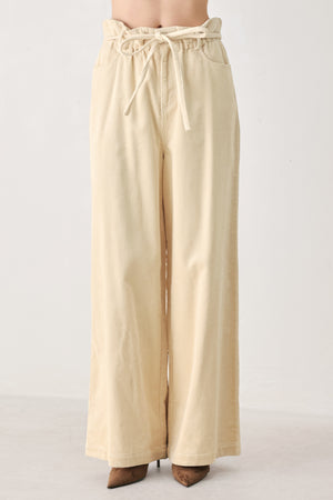 A woman modeling a cream corduroy wide-leg trousers | FREEMARKET