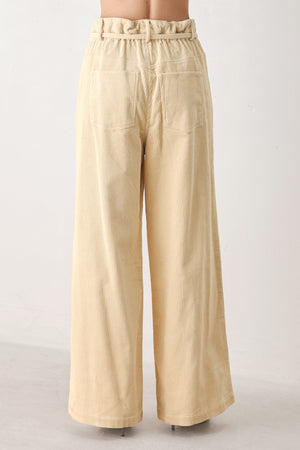 A woman modeling a cream corduroy wide-leg trousers | FREEMARKET
