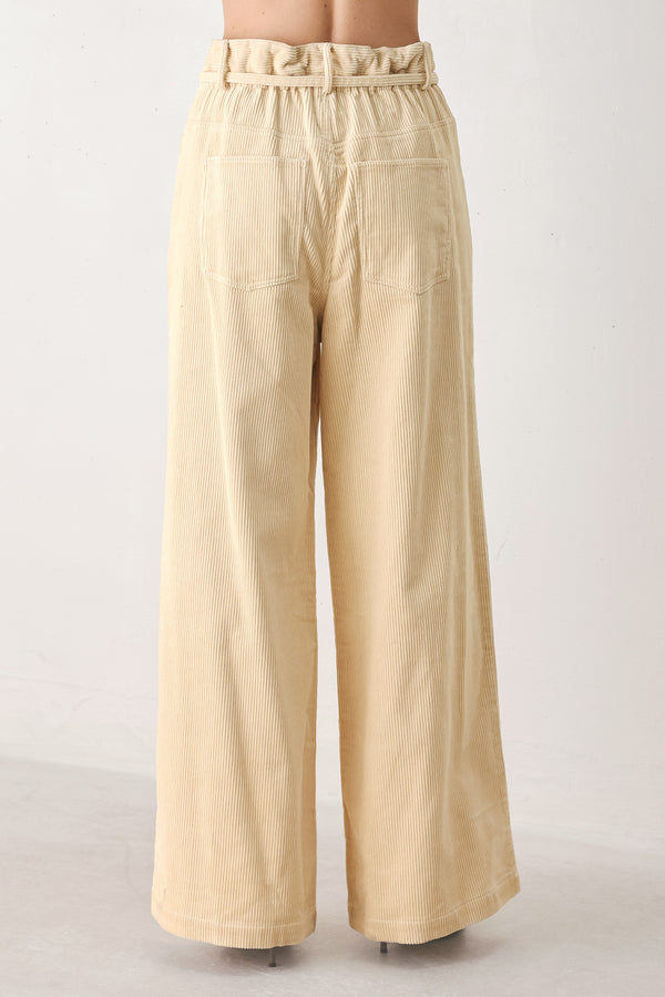 A woman modeling a cream corduroy wide-leg trousers | FREEMARKET