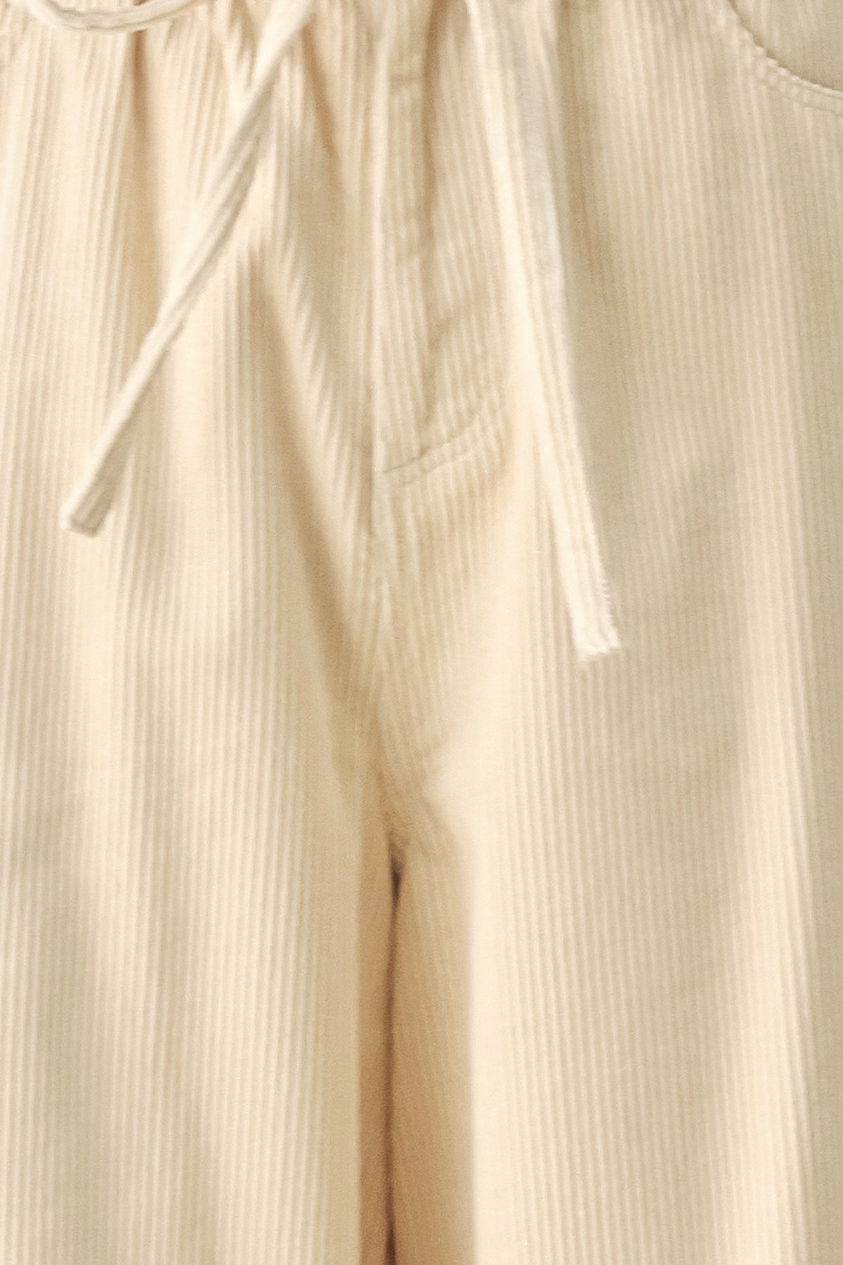 A woman modeling a cream corduroy wide-leg trousers | FREEMARKET