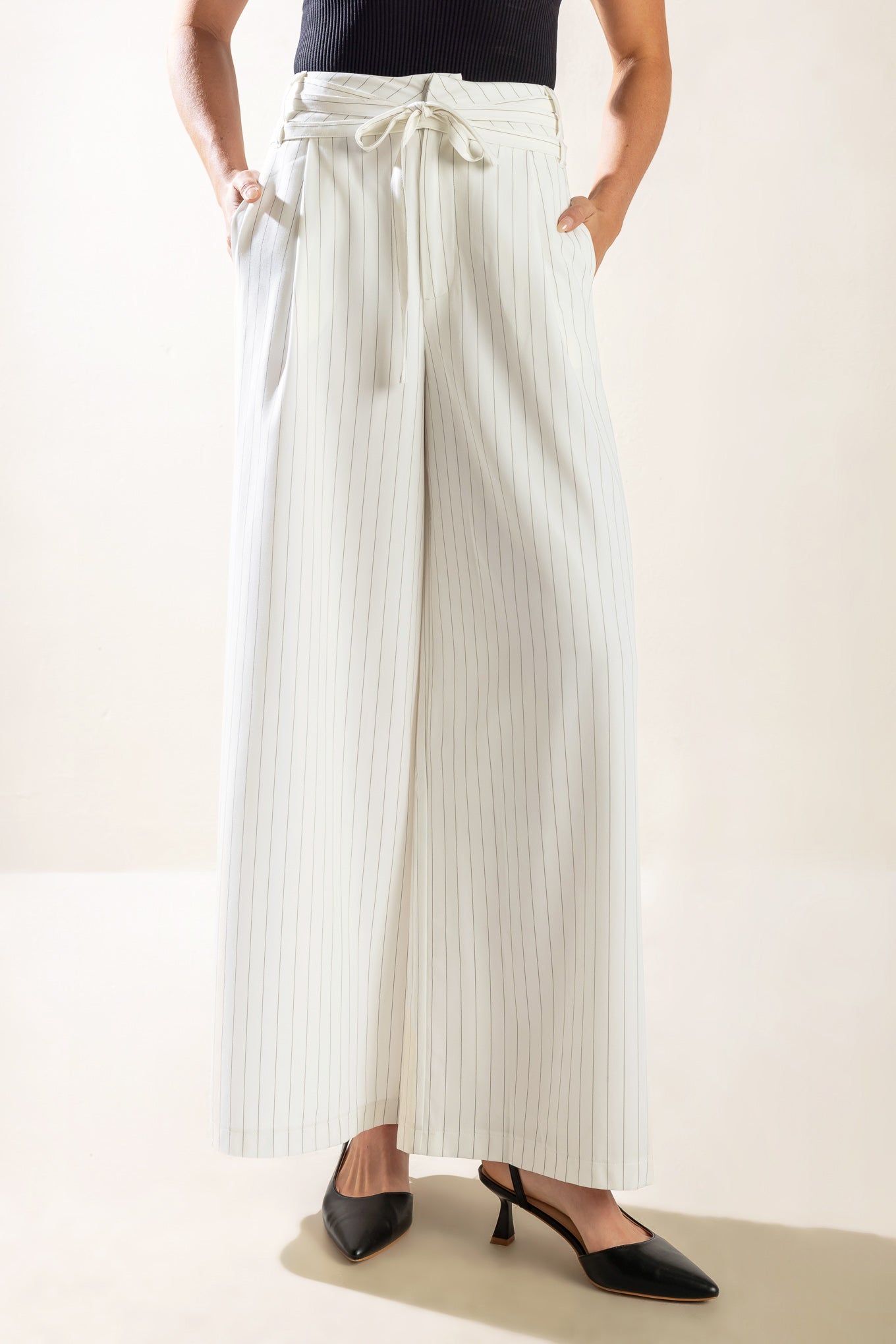 A striped woven pant featuring front closure, side pocket, self sash belt and wide leg. Matching vest FJ1107-W