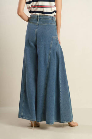 Effortlessly styled with a washed denim finish, these pants include a front closure, side pockets, pleated detailing, and a wide leg for added comfort.