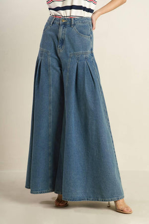 Effortlessly styled with a washed denim finish, these pants include a front closure, side pockets, pleated detailing, and a wide leg for added comfort.