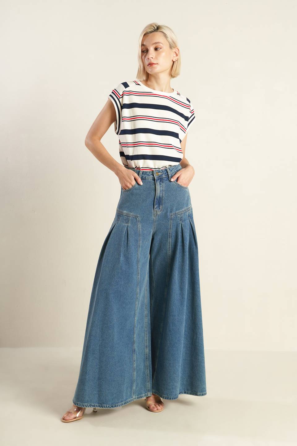 Effortlessly styled with a washed denim finish, these pants include a front closure, side pockets, pleated detailing, and a wide leg for added comfort.