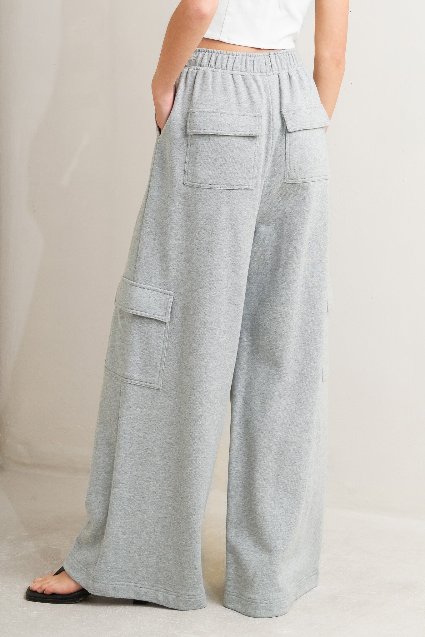 A solid knit pant featuring elasticized waist, side and cargo pockets and wide leg. Matching jacket FJ1105 Flying Tomato