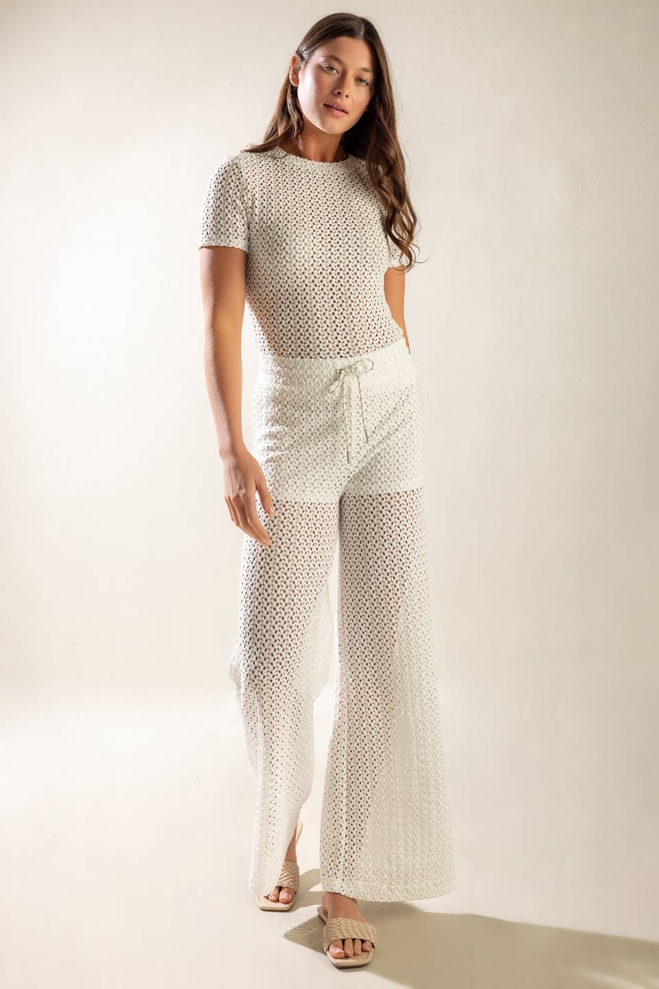 A semi sheer knit pant featuring elasticized waist band, front tie and wide leg with lining.