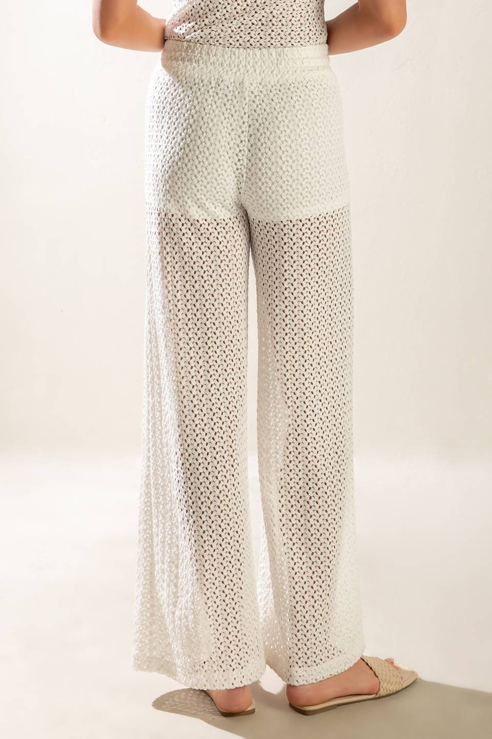 A semi sheer knit pant featuring elasticized waist band, front tie and wide leg with lining.