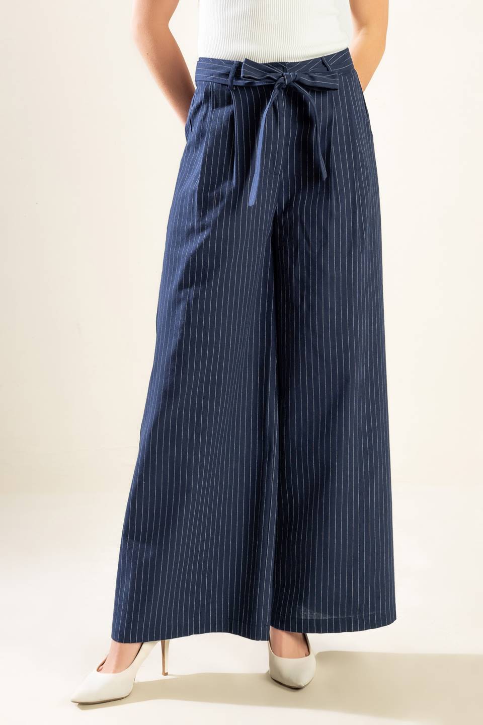 A striped woven pant featuring front closure, self-sash tie, and wide leg. Matching vest WHERE YOU BELONG WOVEN VEST.