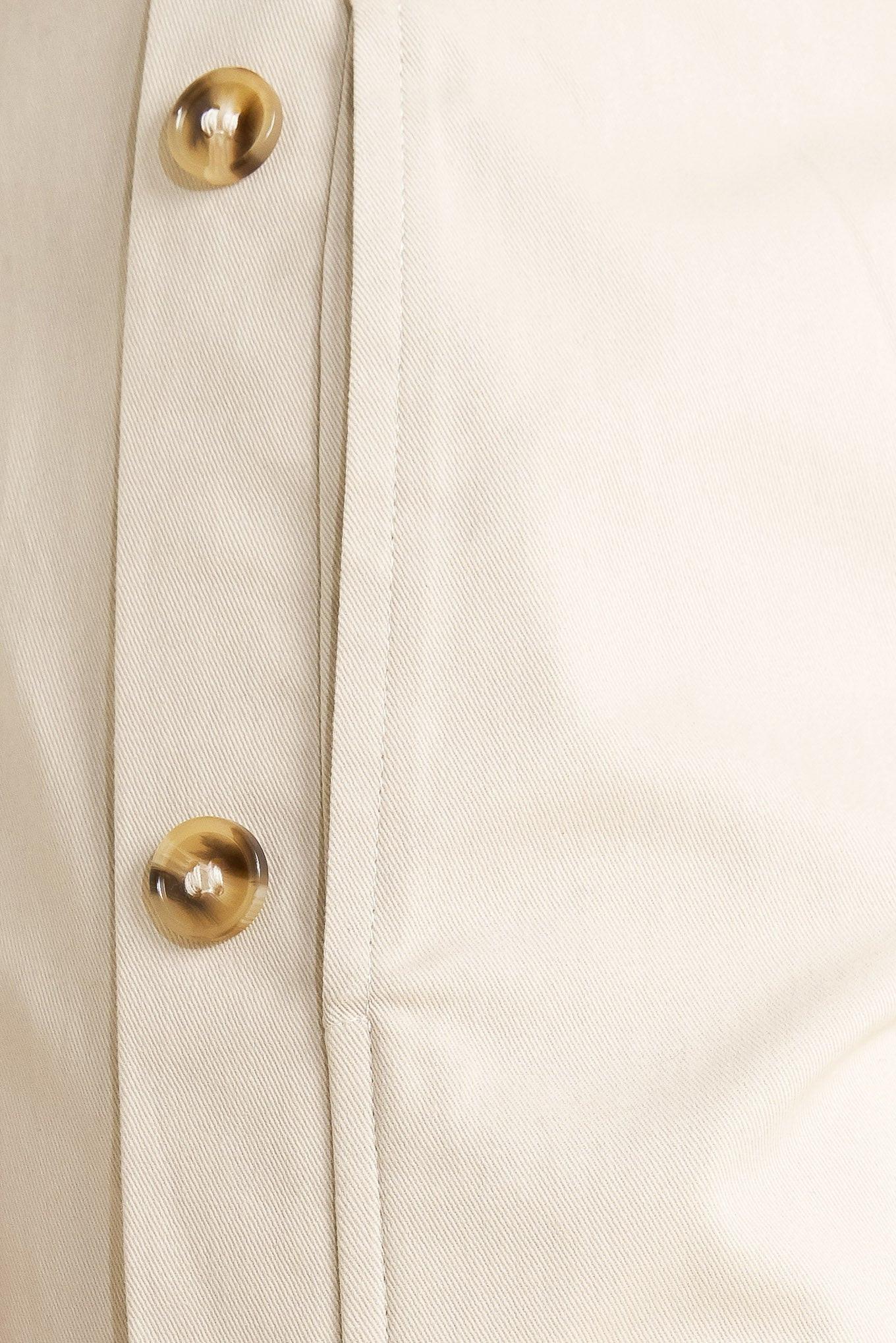 A solid woven pant featuring front closure, side button down, wide leg and skinny belt