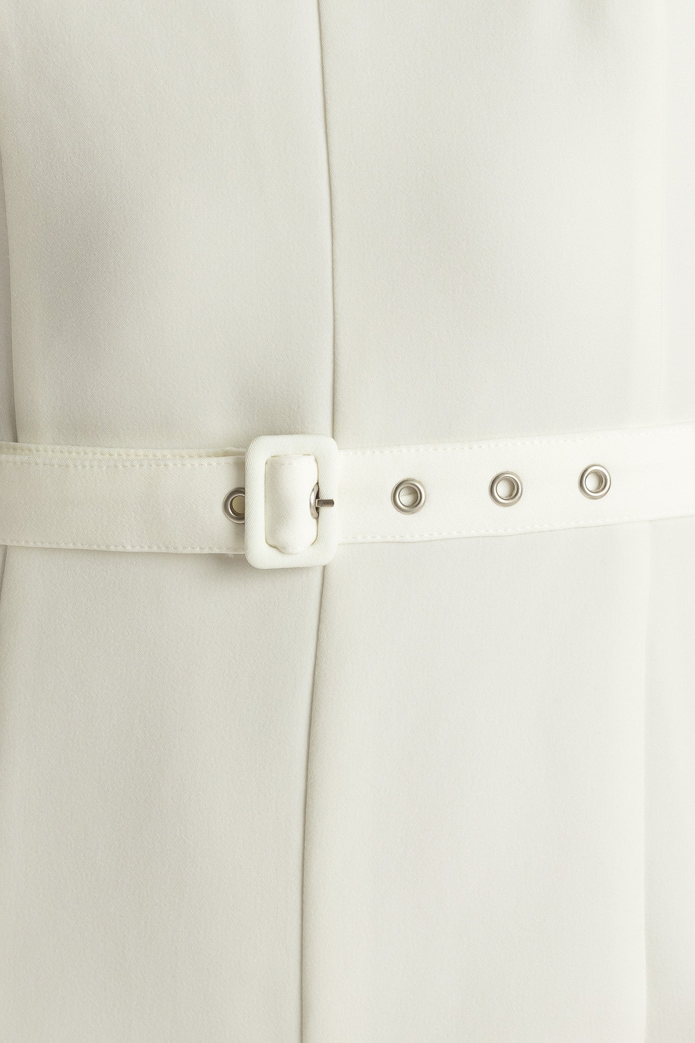 Woman wearing a sleeveless white jumpsuit featuring wide neckline, self belt, wide leg and back zipper closure | FREEMARKET