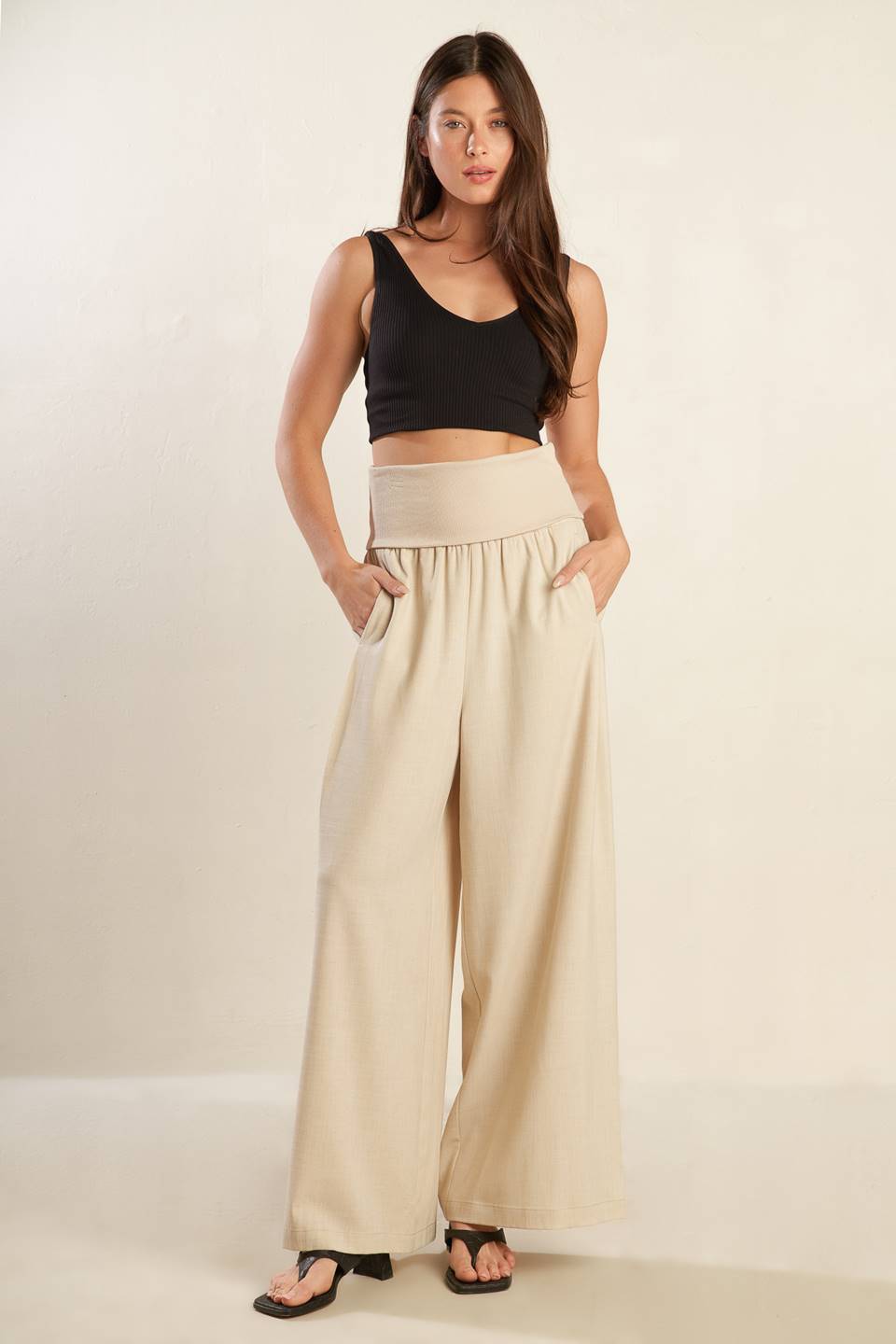 A solid beige woven pant featuring knit waist fold over and wide leg.