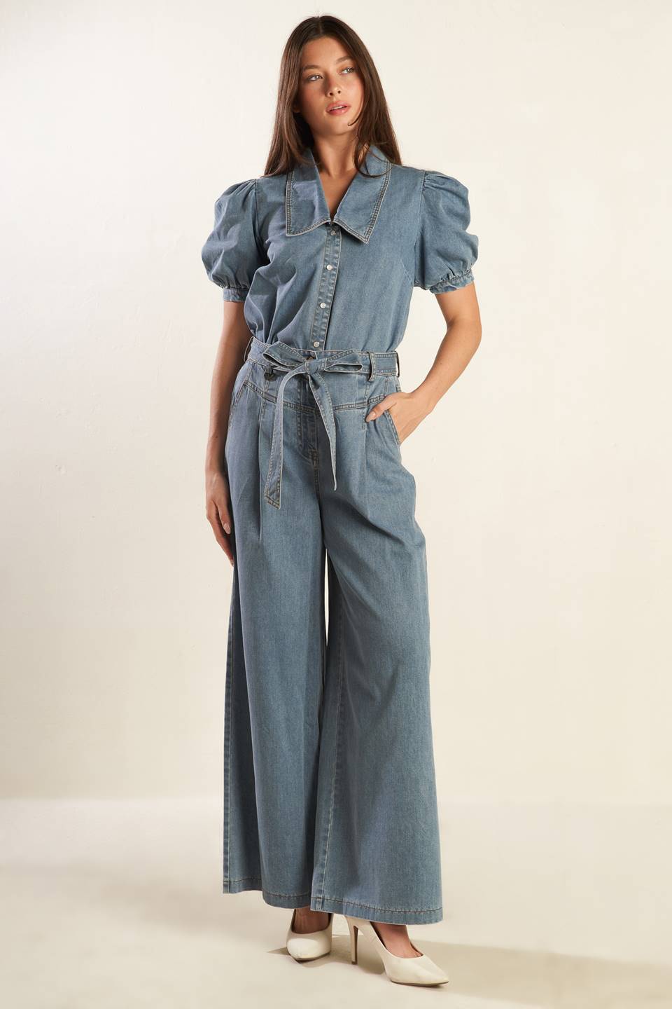 A washed light denim pant featuring front closure with self belt, side pockets, wide leg and elasticized back waistband.