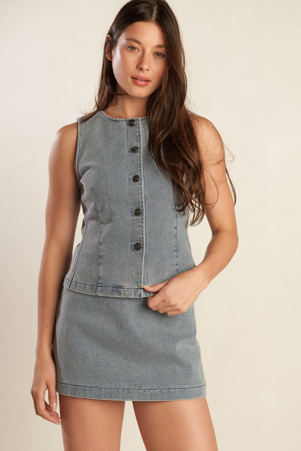 A solid denim mini skort with side zipper closure and back pockets.