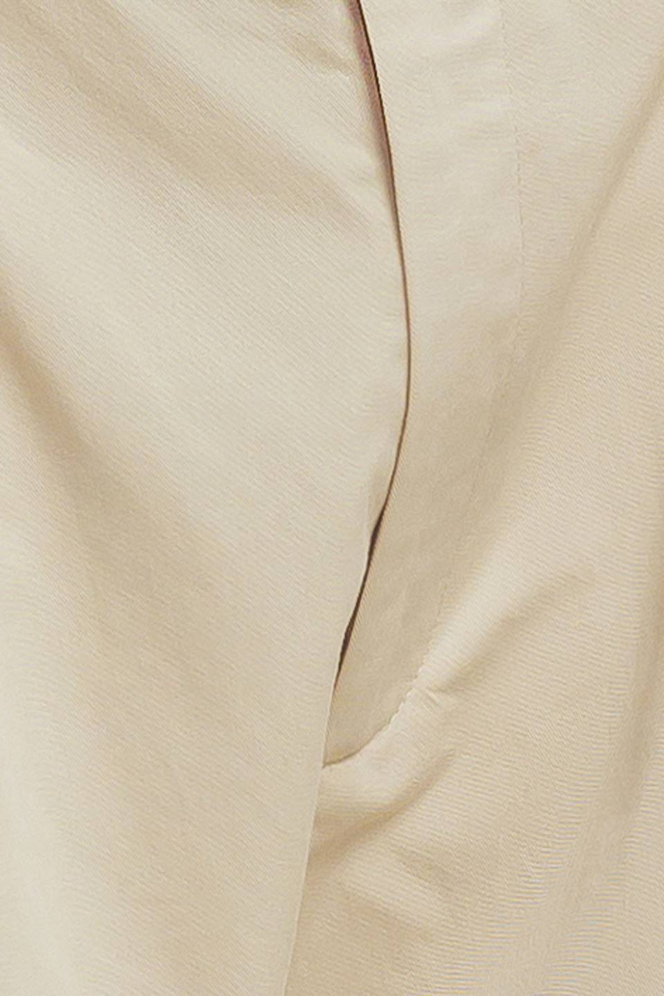 A solid woven bermuda short featuring front closure and self belt.