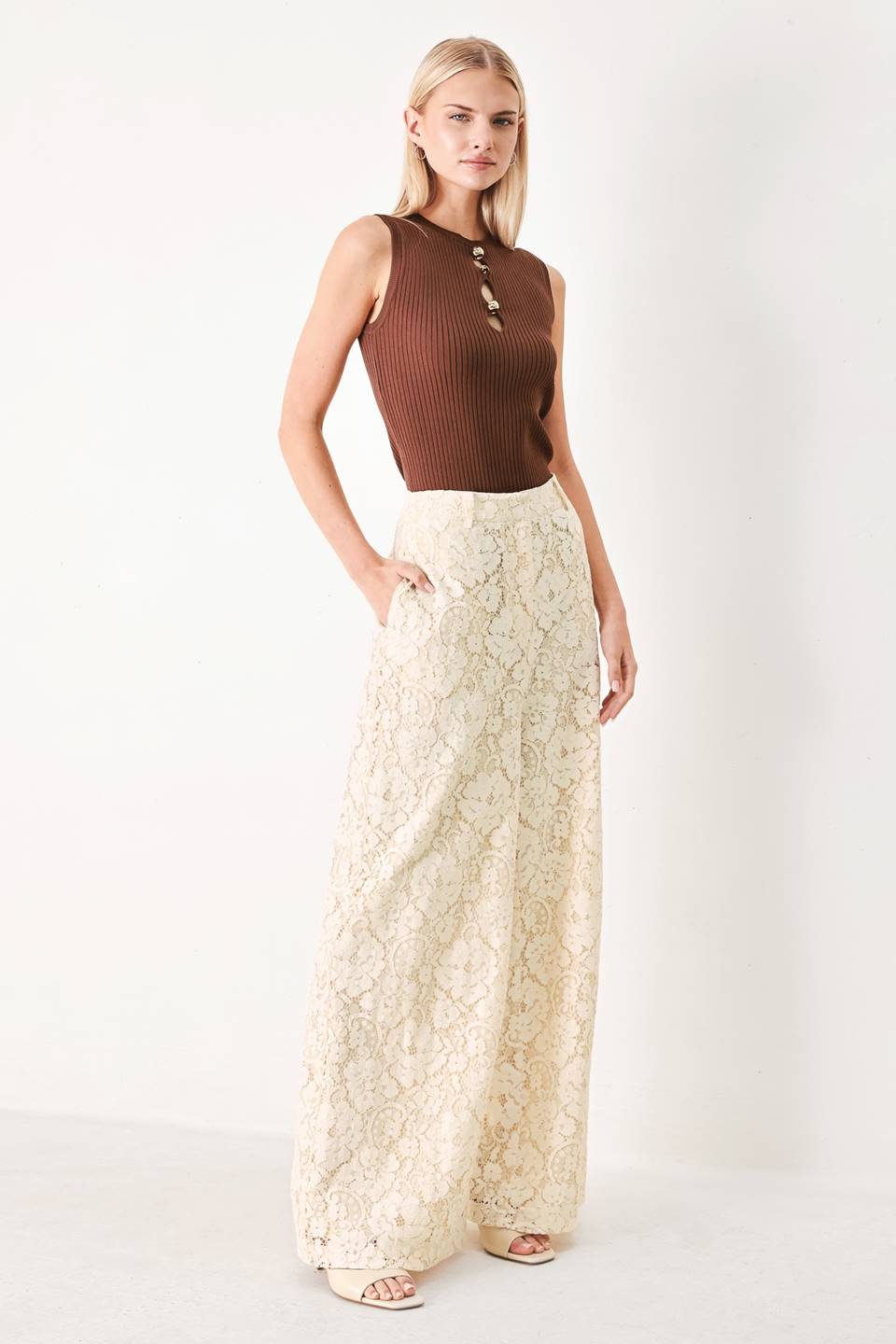 Woman wearing white lace pants with front closure and wide leg | FREEMARKET