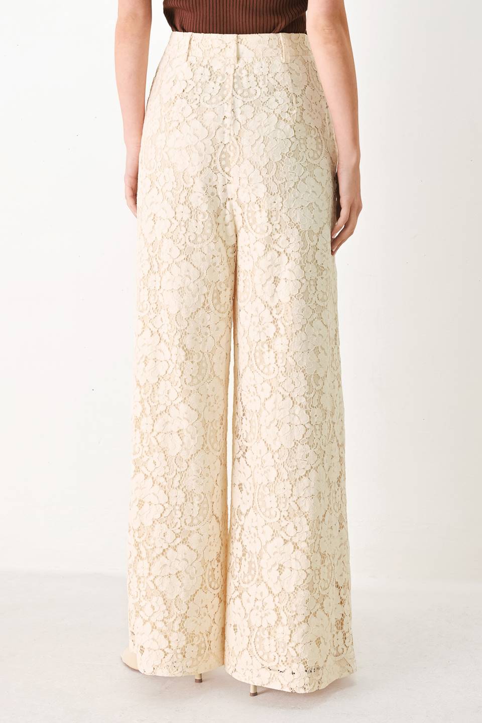Woman wearing white lace pants with front closure and wide leg | FREEMARKET