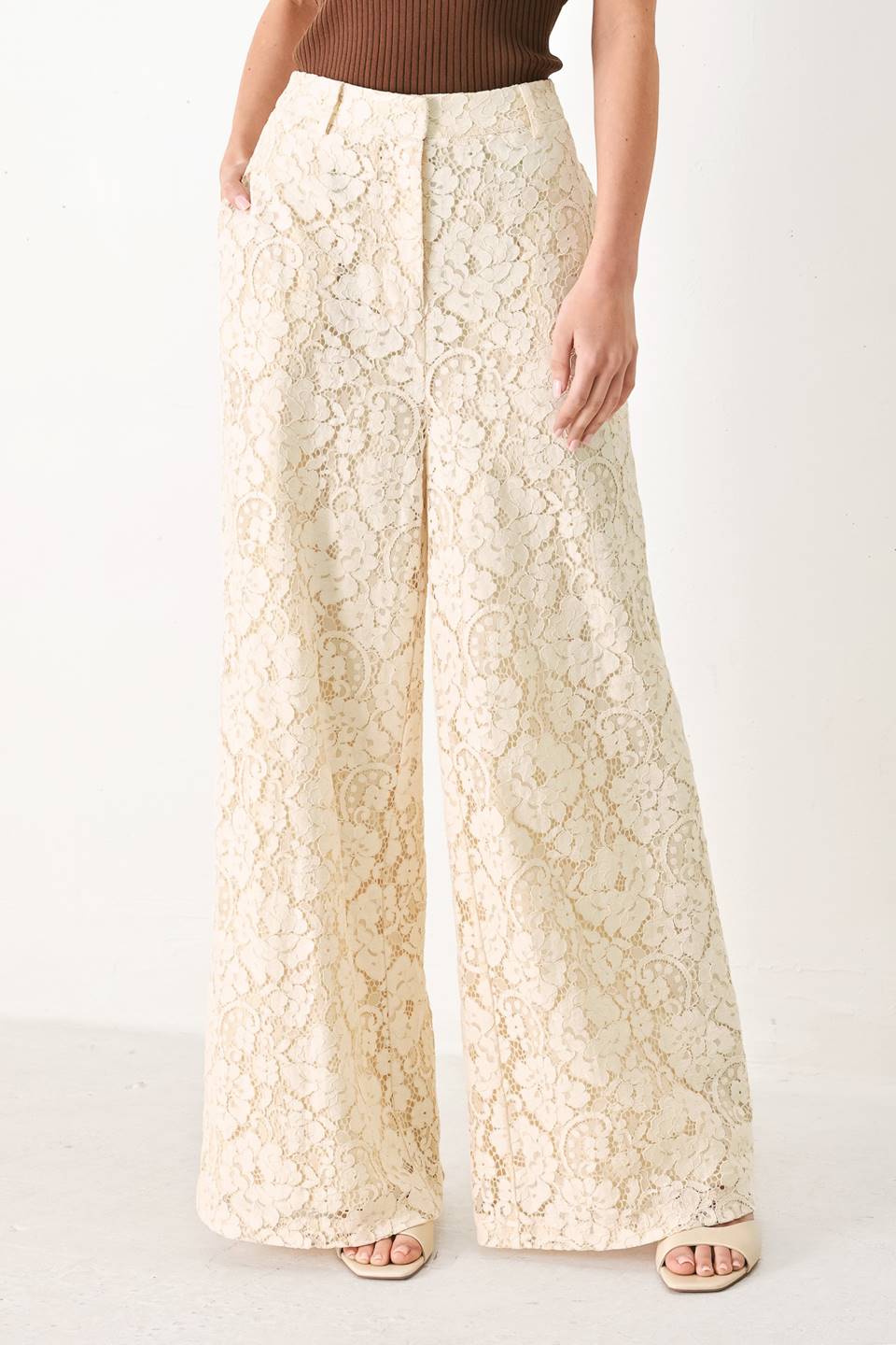 Woman wearing white lace pants with front closure and wide leg | FREEMARKET