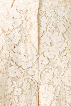 Close up of white lace pants with front closure and wide leg | FREEMARKET