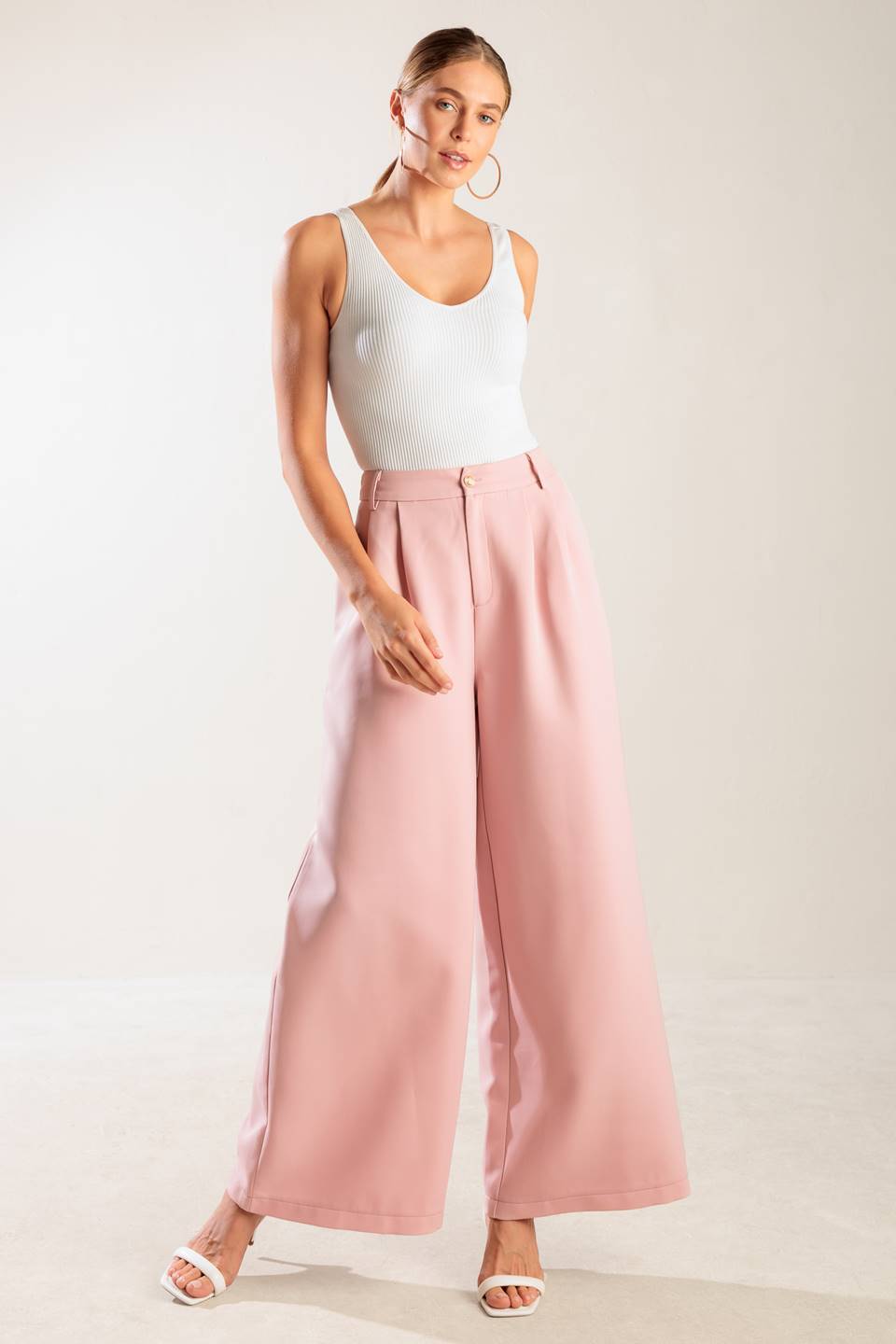 A solid woven pant featuring front closure, side pockets, and wide leg.