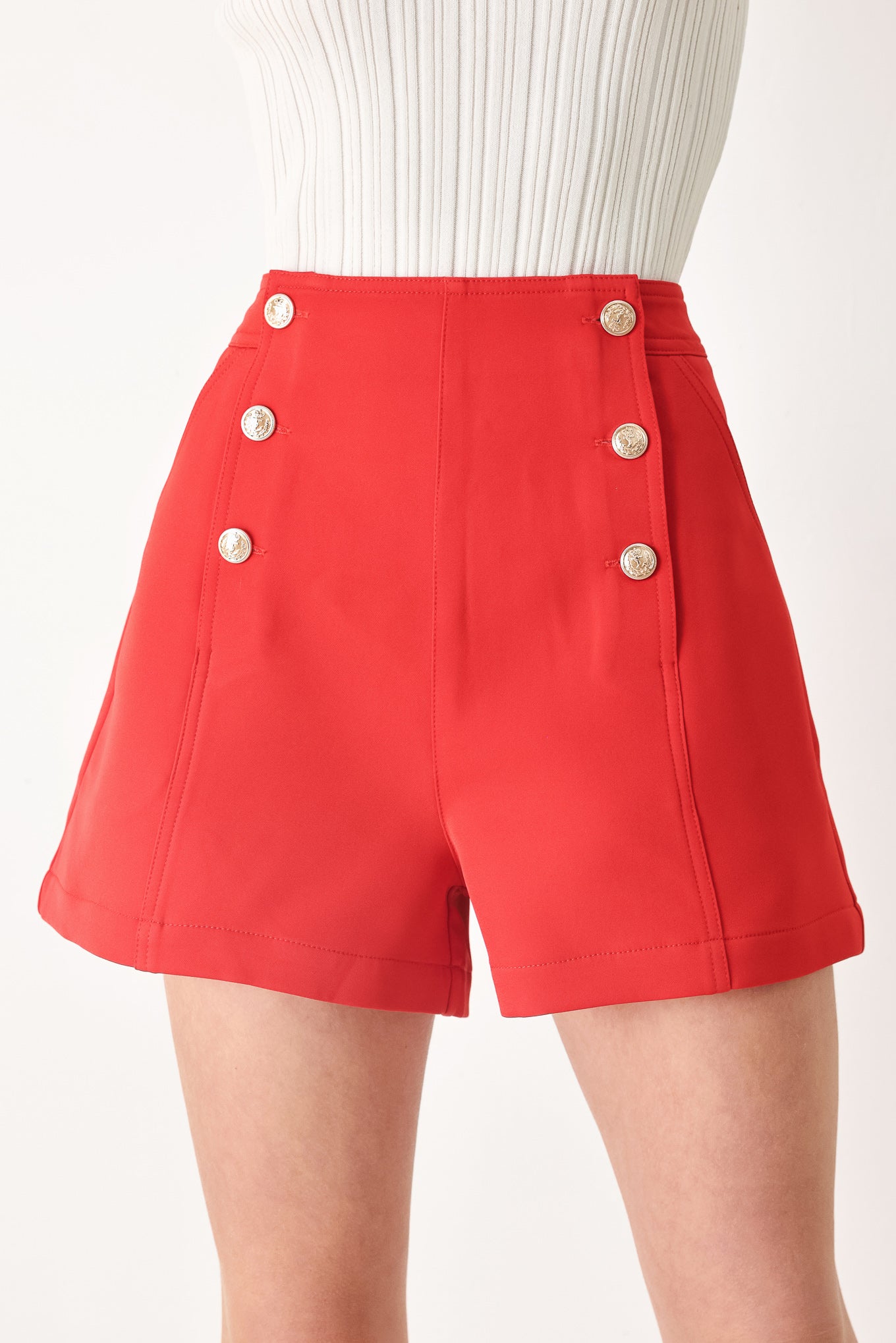 Woman wearing red shorts with buttons | FREEMARKET