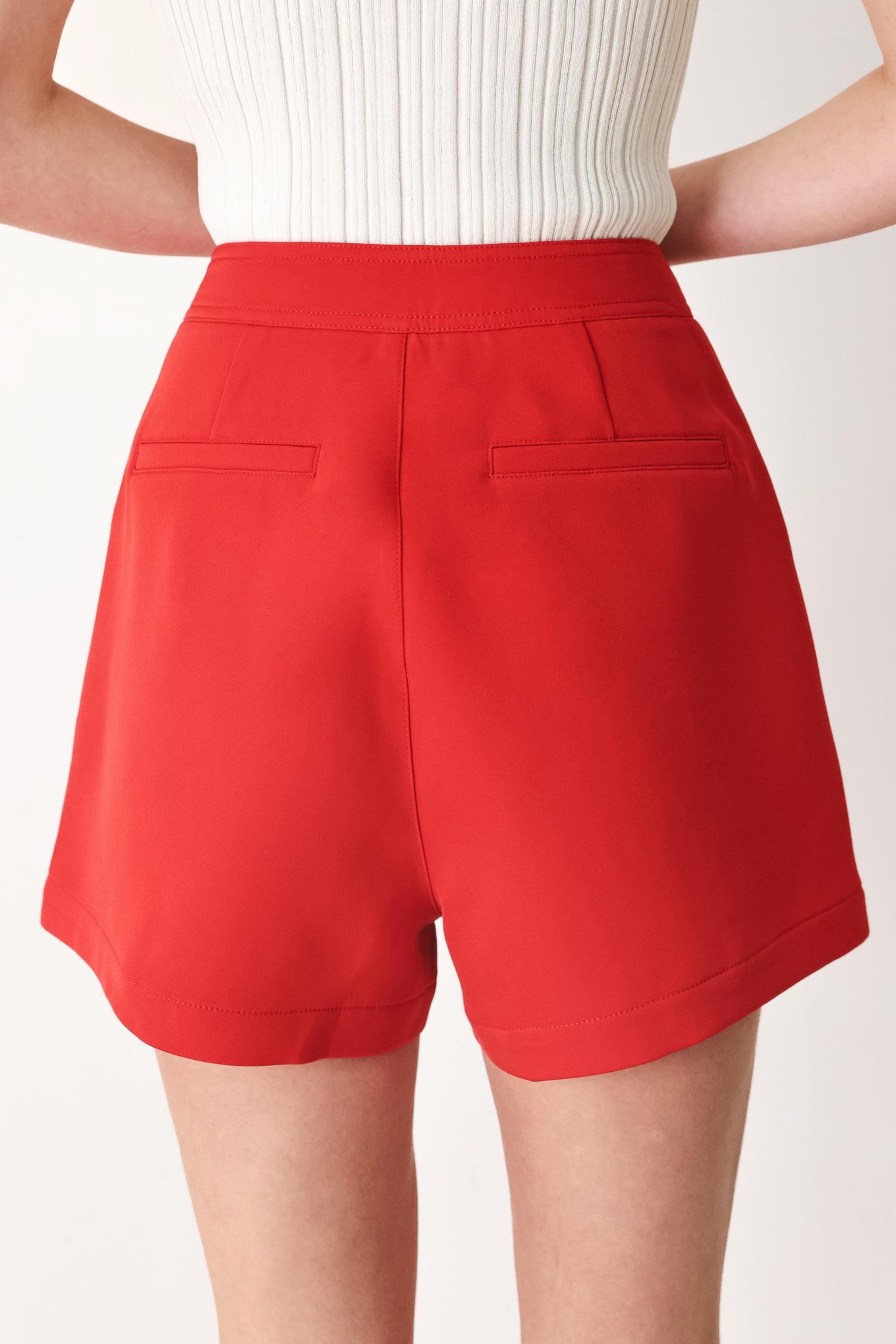 Woman wearing red shorts with buttons | FREEMARKET
