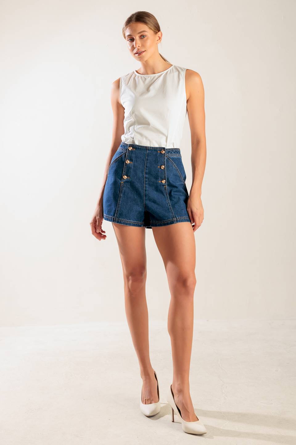 A denim short featuring front double button closure and front/back pockets.