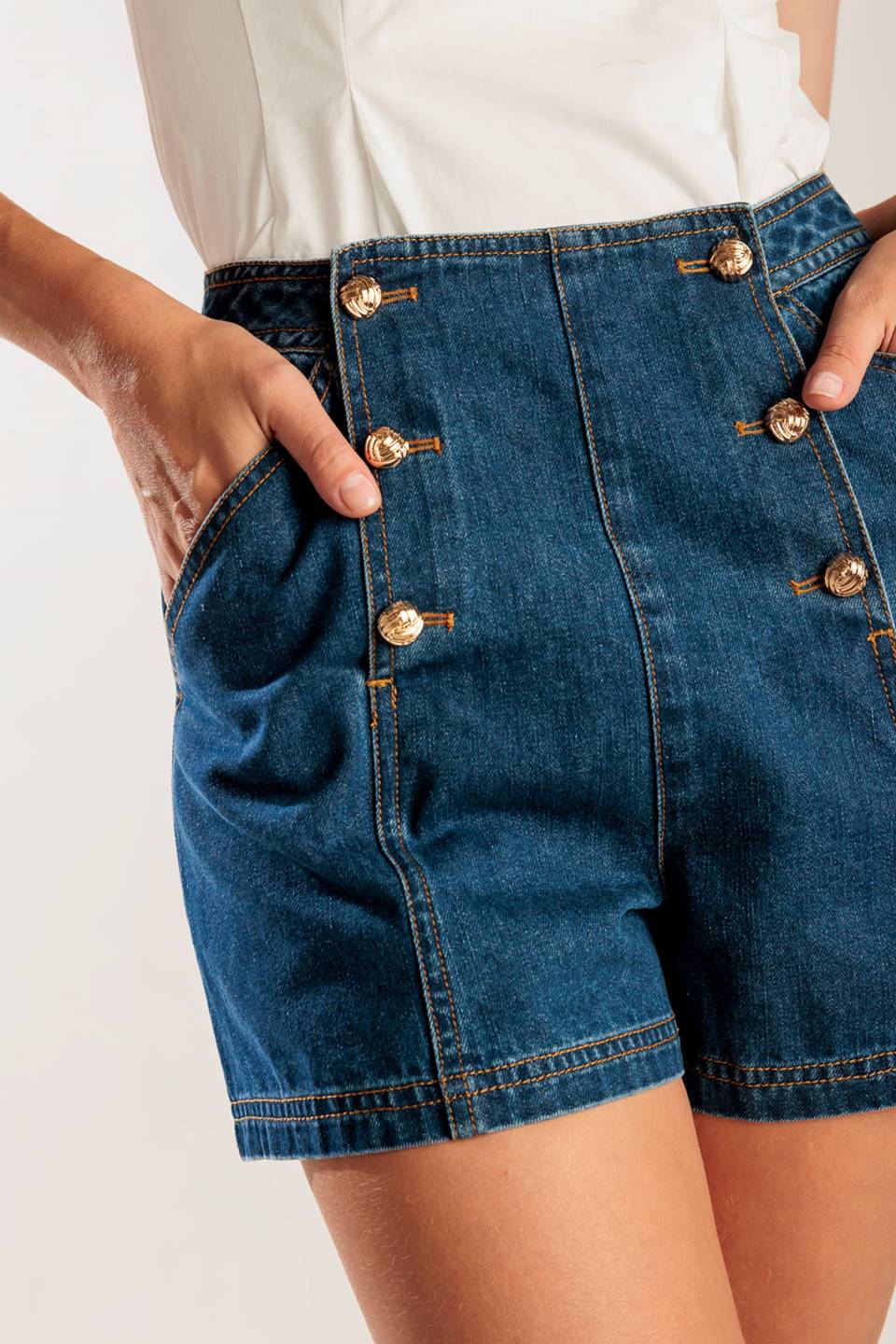 A denim short featuring front double button closure and front/back pockets.