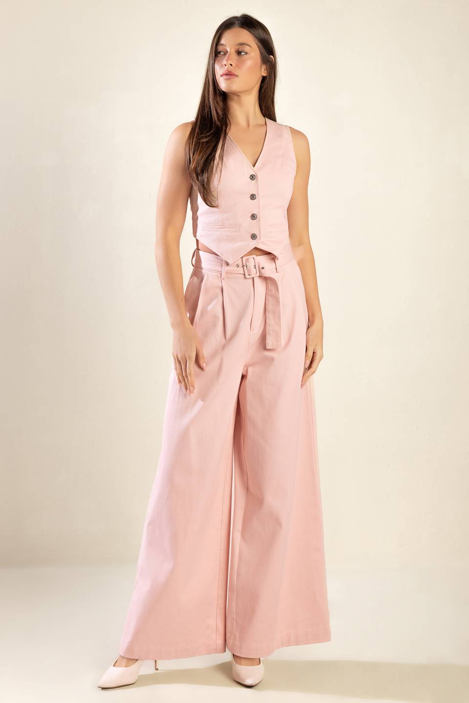 Constructed from high-quality woven material, these pink pants boast a stylish front closure, a convenient self belt, functional pockets, and a flattering wide leg design.