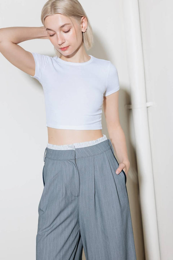 A striped woven pant featuring contrasting edge waist band, front pleat, side pockets, side stripe detail and wide leg.
