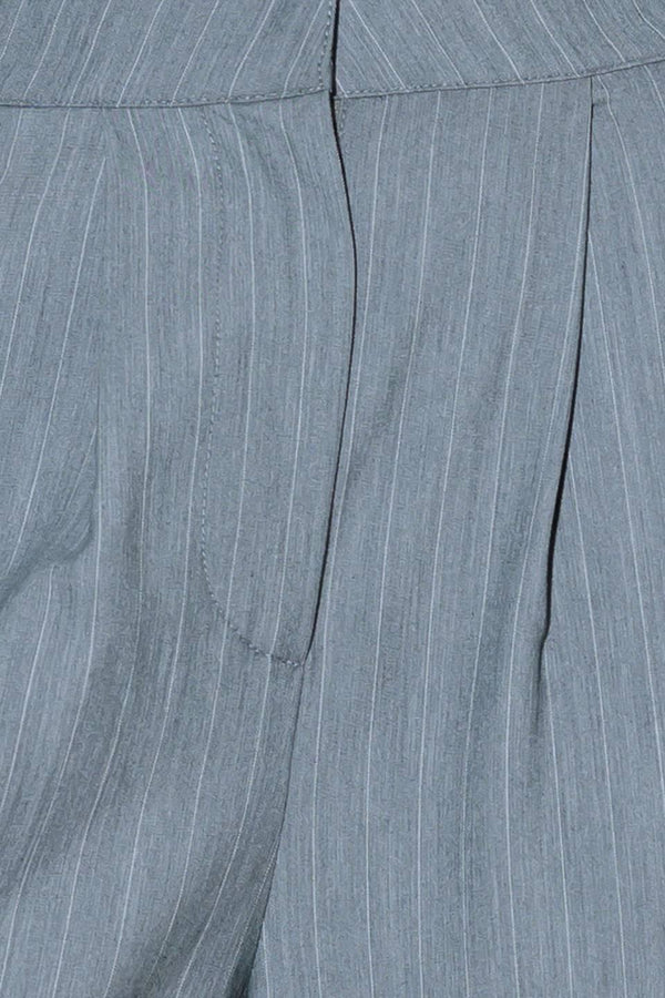A striped woven pant featuring contrasting edge waist band, front pleat, side pockets, side stripe detail and wide leg.