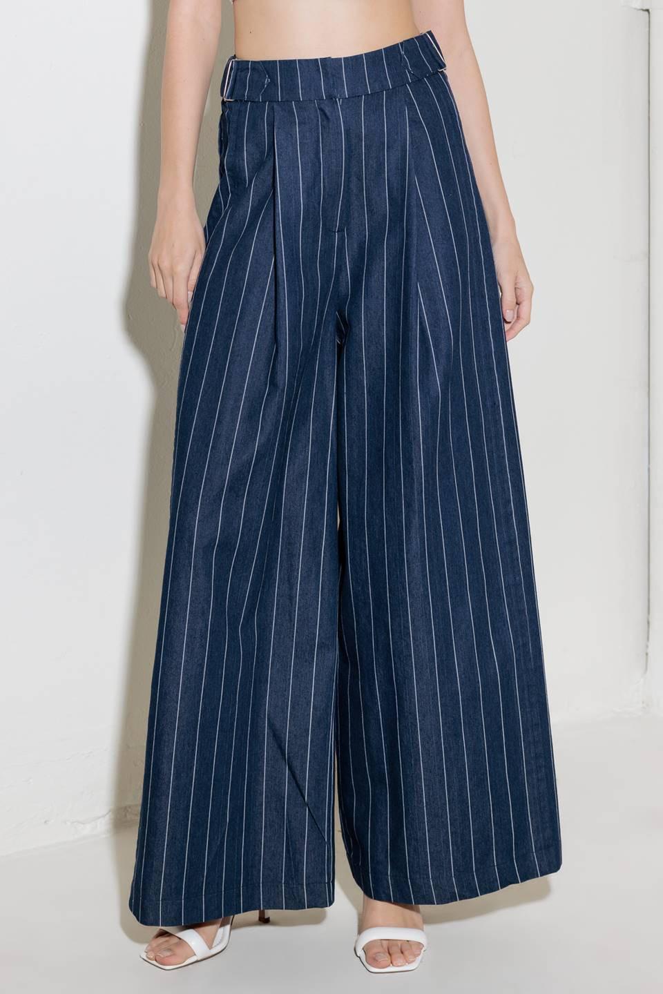 A striped woven pant featuring front closure, side tab, pockets and wide leg.