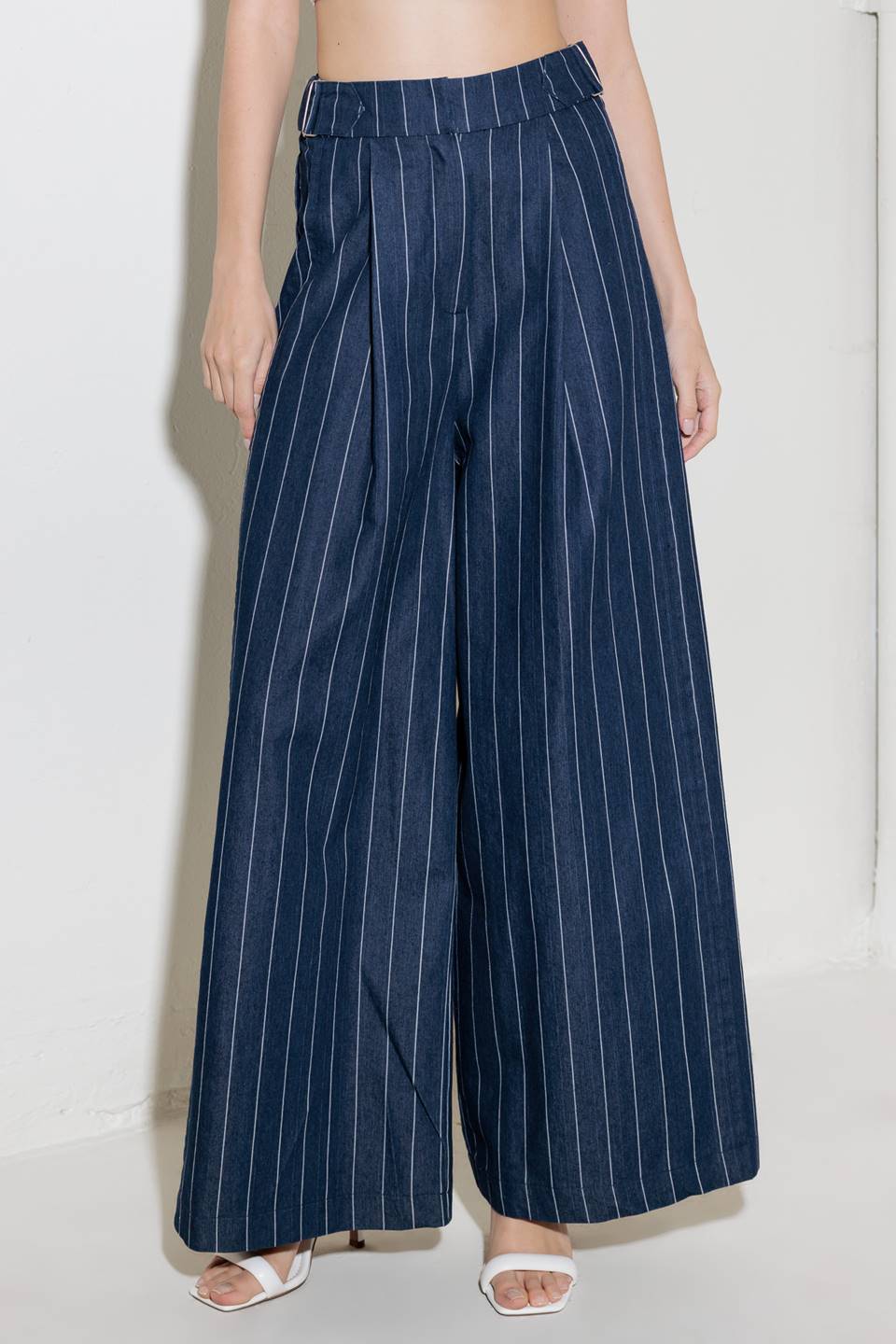 A striped woven pant featuring front closure, side tab, pockets and wide leg.