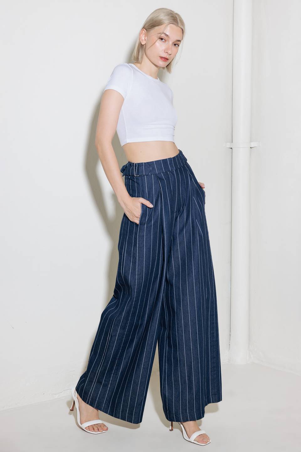 A striped woven pant featuring front closure, side tab, pockets and wide leg.