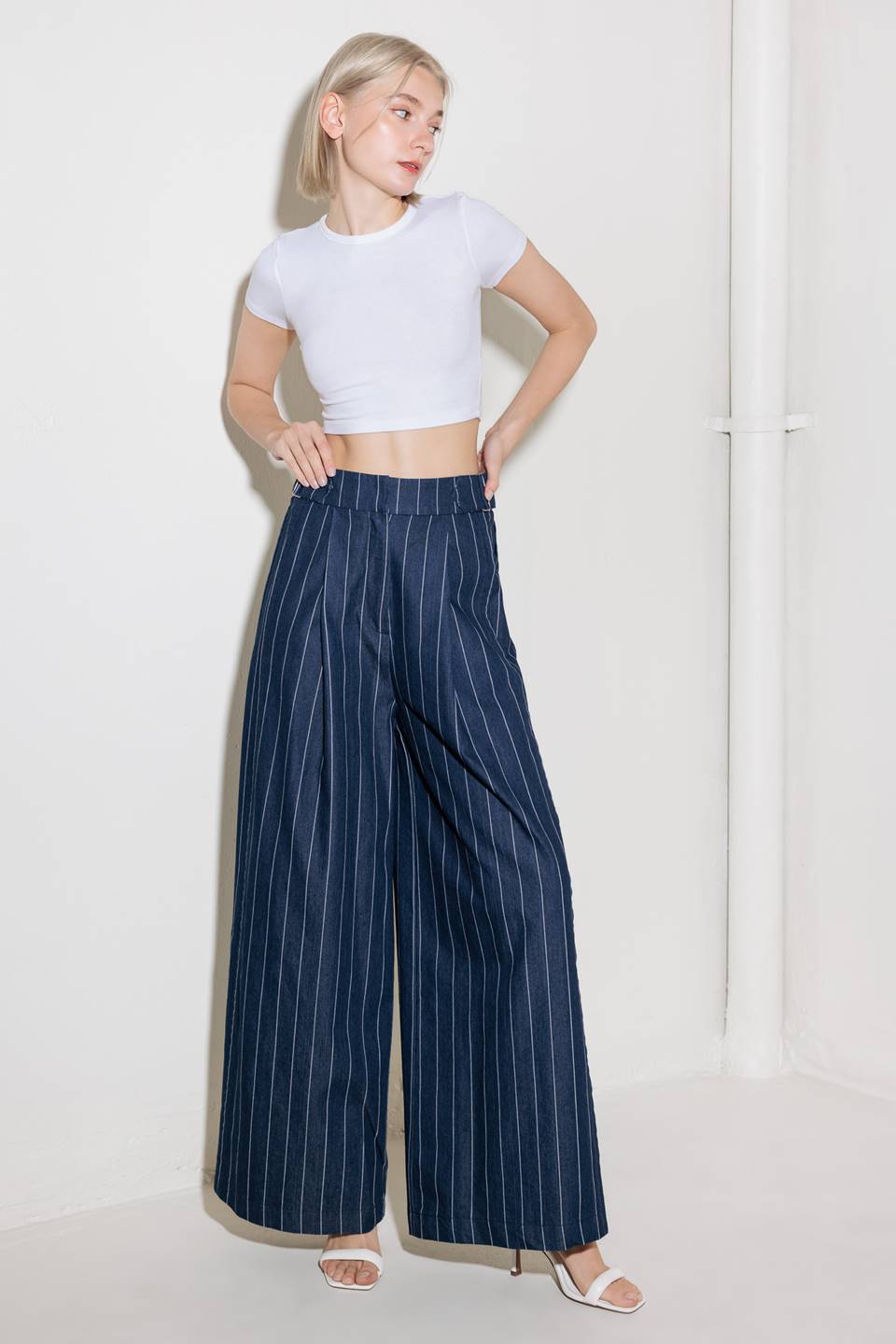 A striped woven pant featuring front closure, side tab, pockets and wide leg.
