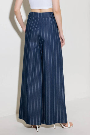 A striped woven pant featuring front closure, side tab, pockets and wide leg.
