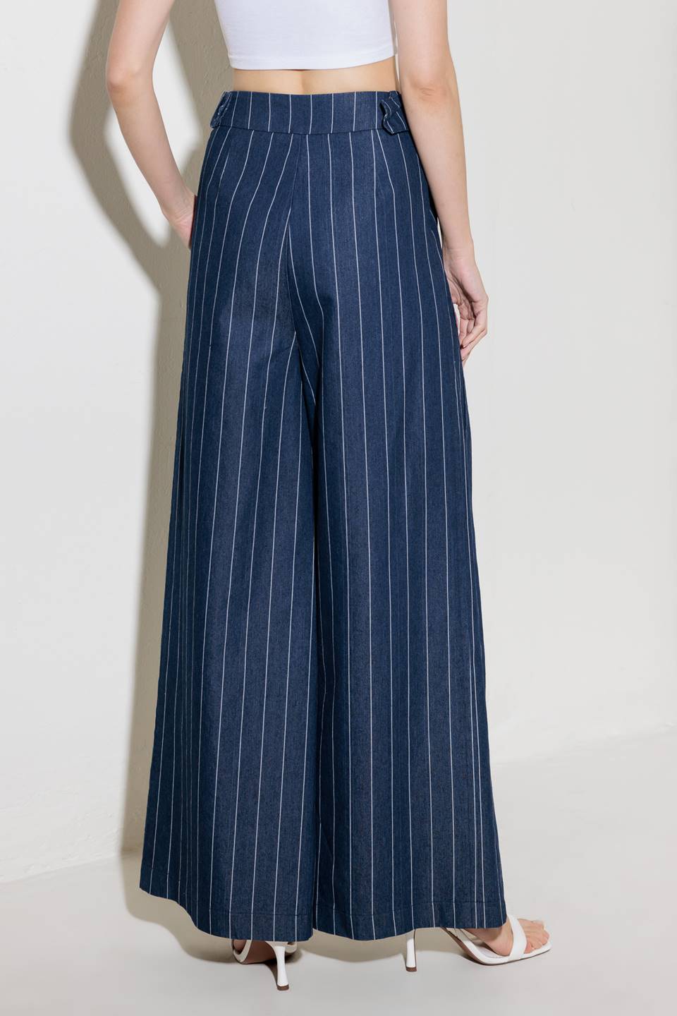 A striped woven pant featuring front closure, side tab, pockets and wide leg.