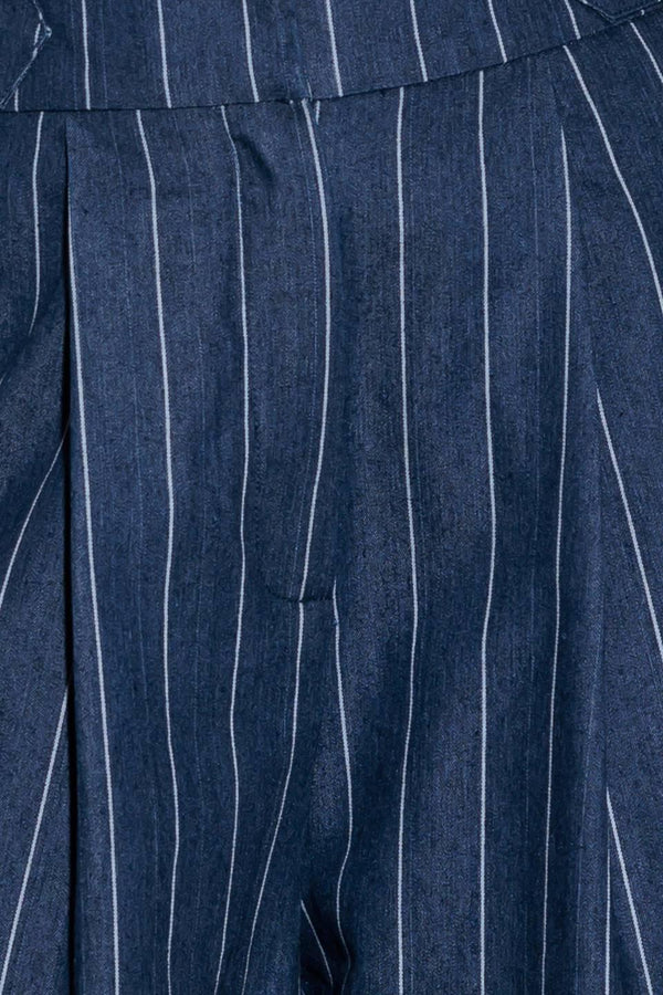 A striped woven pant featuring front closure, side tab, pockets and wide leg.